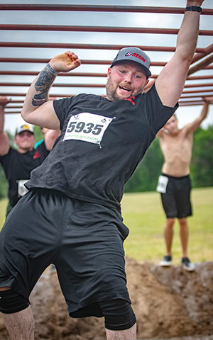 Man Swinging on Monkey Bars