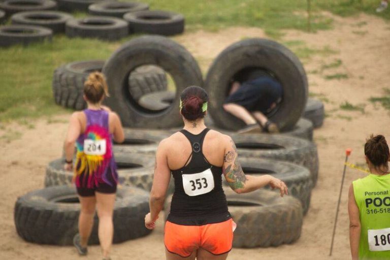 Women Running Through Tires Obstacle